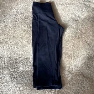 Lululemon size 8, black cropped leggings, cute scallop detail at back zipper.